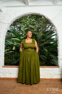 Olive green UMBO corset maxi skirt, full-length view on a verandah