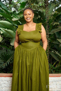 Olive green UMBO corset maxi skirt, full-length view on a verandah