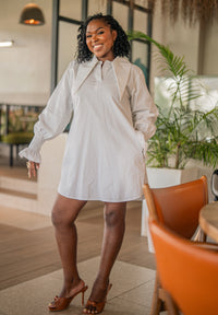 White CHETU shirt dress with a long collar and puff sleeves, full-length front view at a restaurant