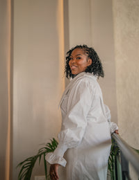 Waist-up side view of the white CHETU shirt dress