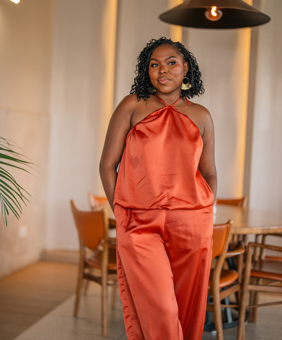 Terracotta Maputo top and pants set, full-length front view at a restaurant