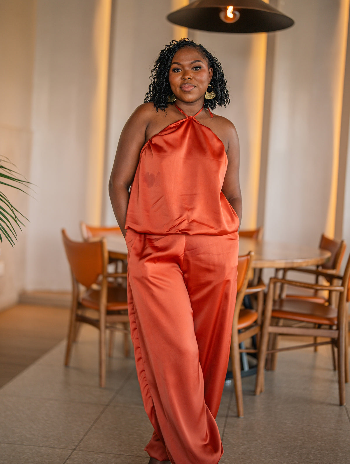 Terracotta Maputo top and pants set, full-length front view at a restaurant