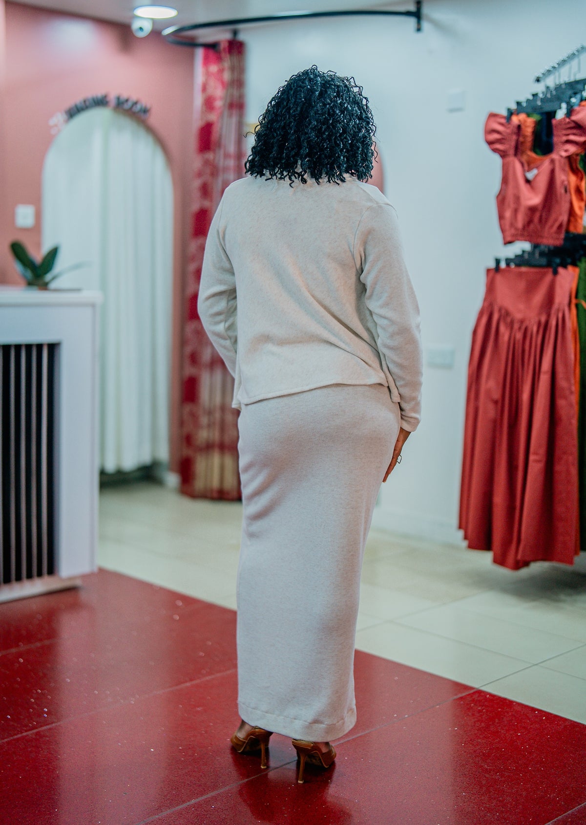 Beige Msimu knit waterfall sweater top worn over the Msimu maxi dress, back view