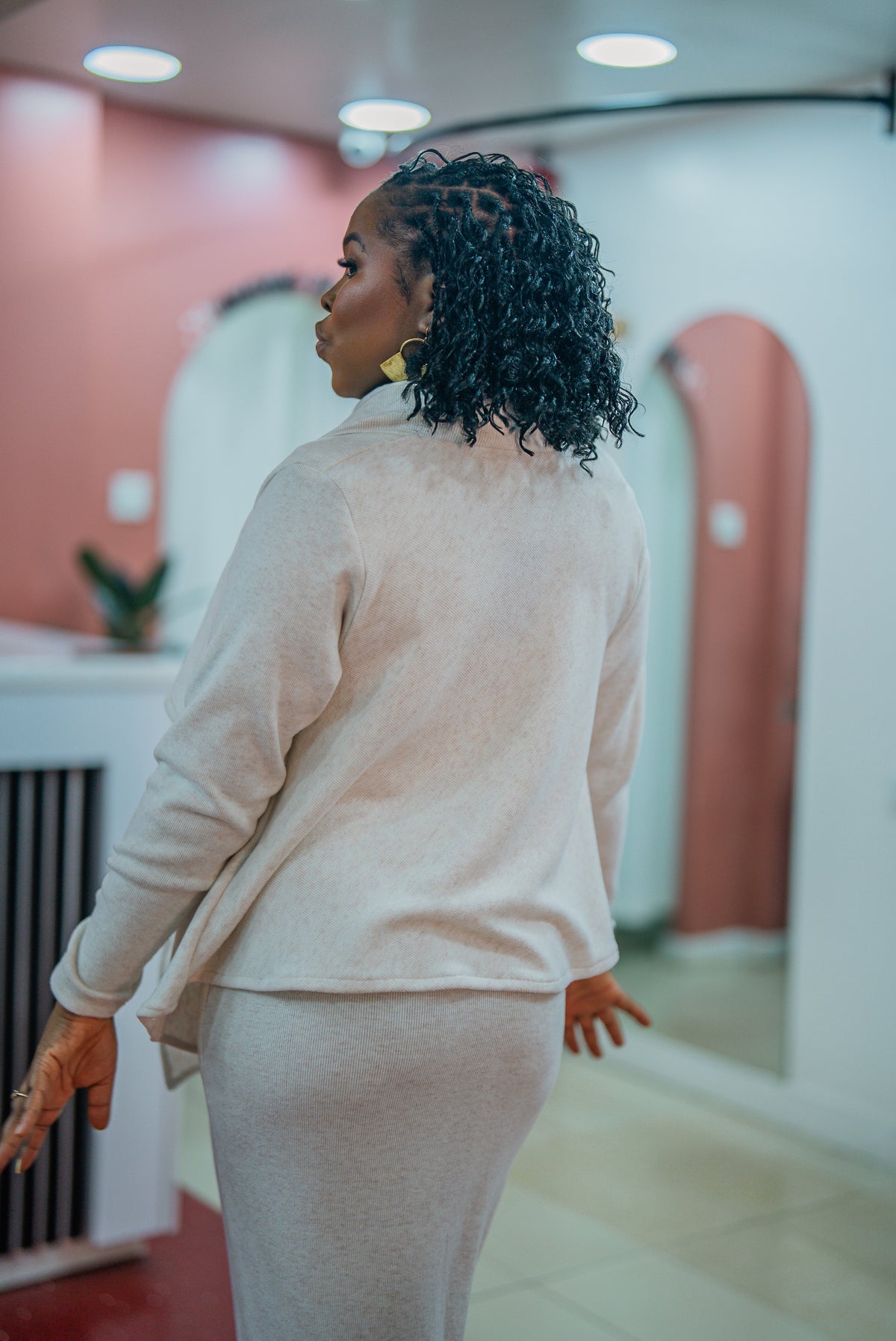 Back view of the beige Msimu waterfall sweater top