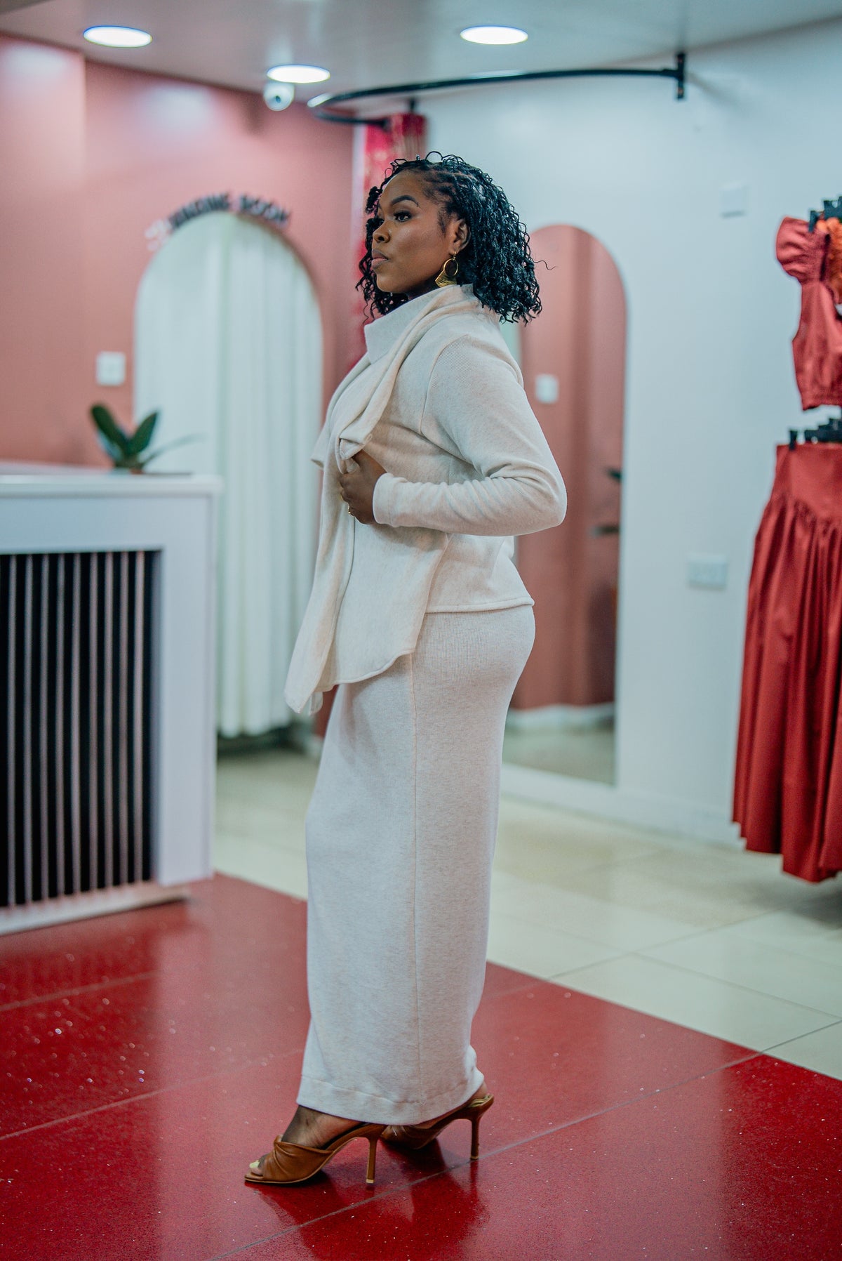 Side view of the beige Msimu waterfall sweater top
