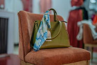 Lana scarf tied on the olive green INKA bag