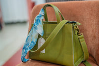 Lana scarf tied on the olive green INKA bag